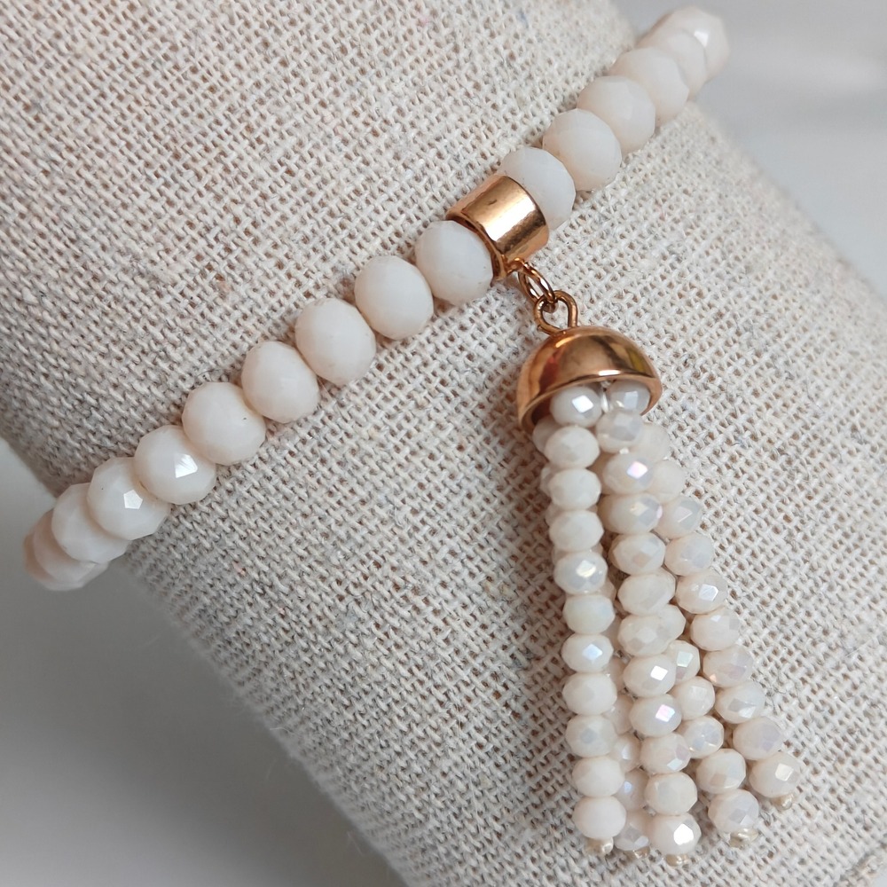 Cream Faceted Glass Beaded Stretch Bracelet with Gold Tone Tassel Charm